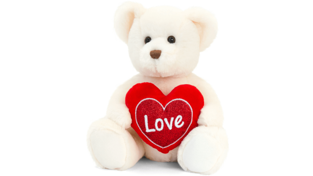 a cream teddy bear holding a heart cushion with the word 'love' on it