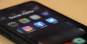 social media icons on black phone screen