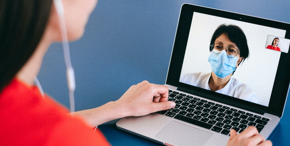 woman on video call to woman wearing a face mask